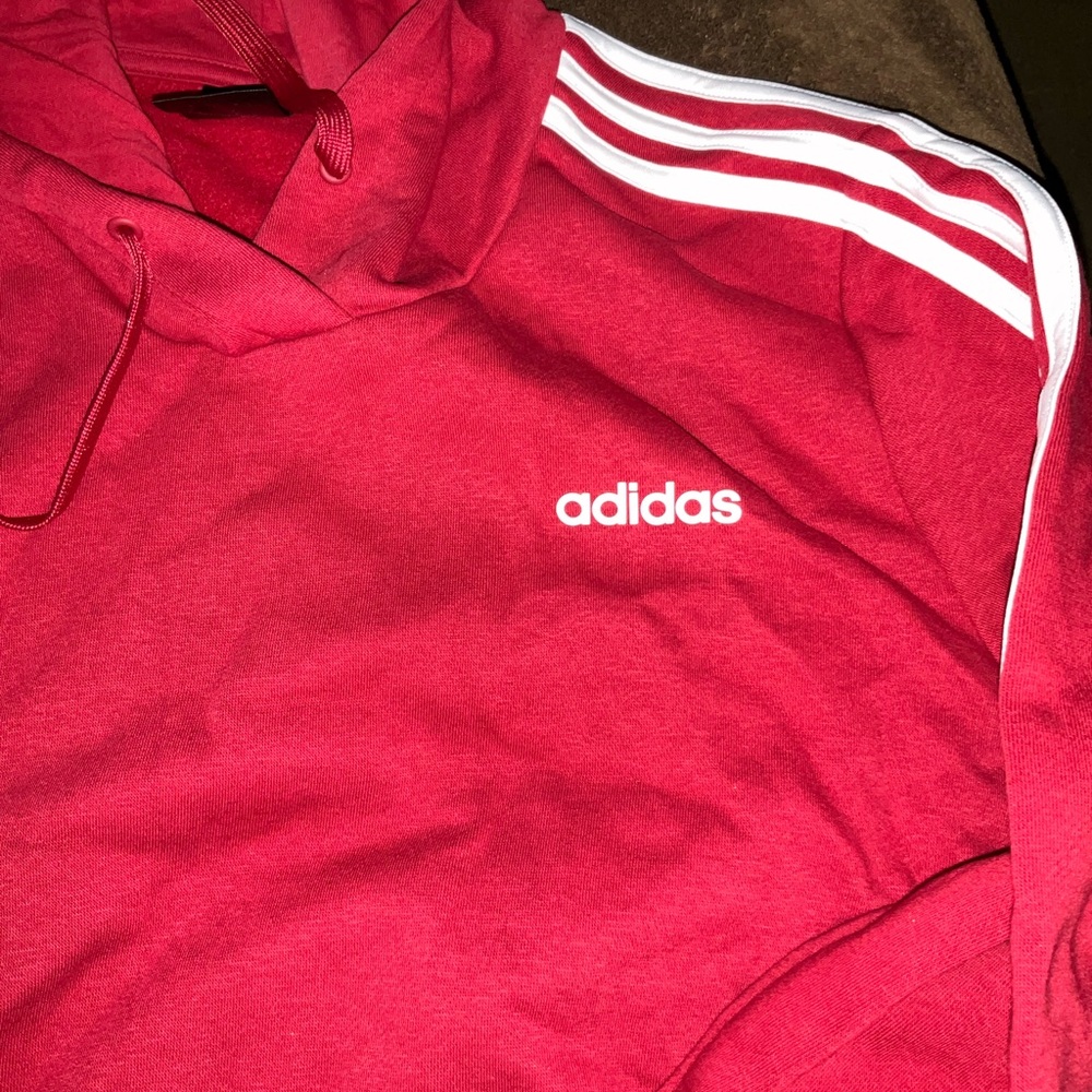 Adidas Red Hoodie with White Stripes it’s a Maroon Cranberry Color and